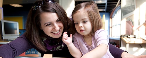 a girl sitting on a table