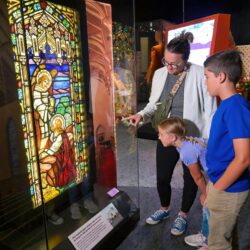 A Man And A Woman Standing In Front Of A Building