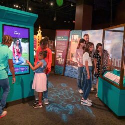 A Group Of People Standing In Front Of A Store